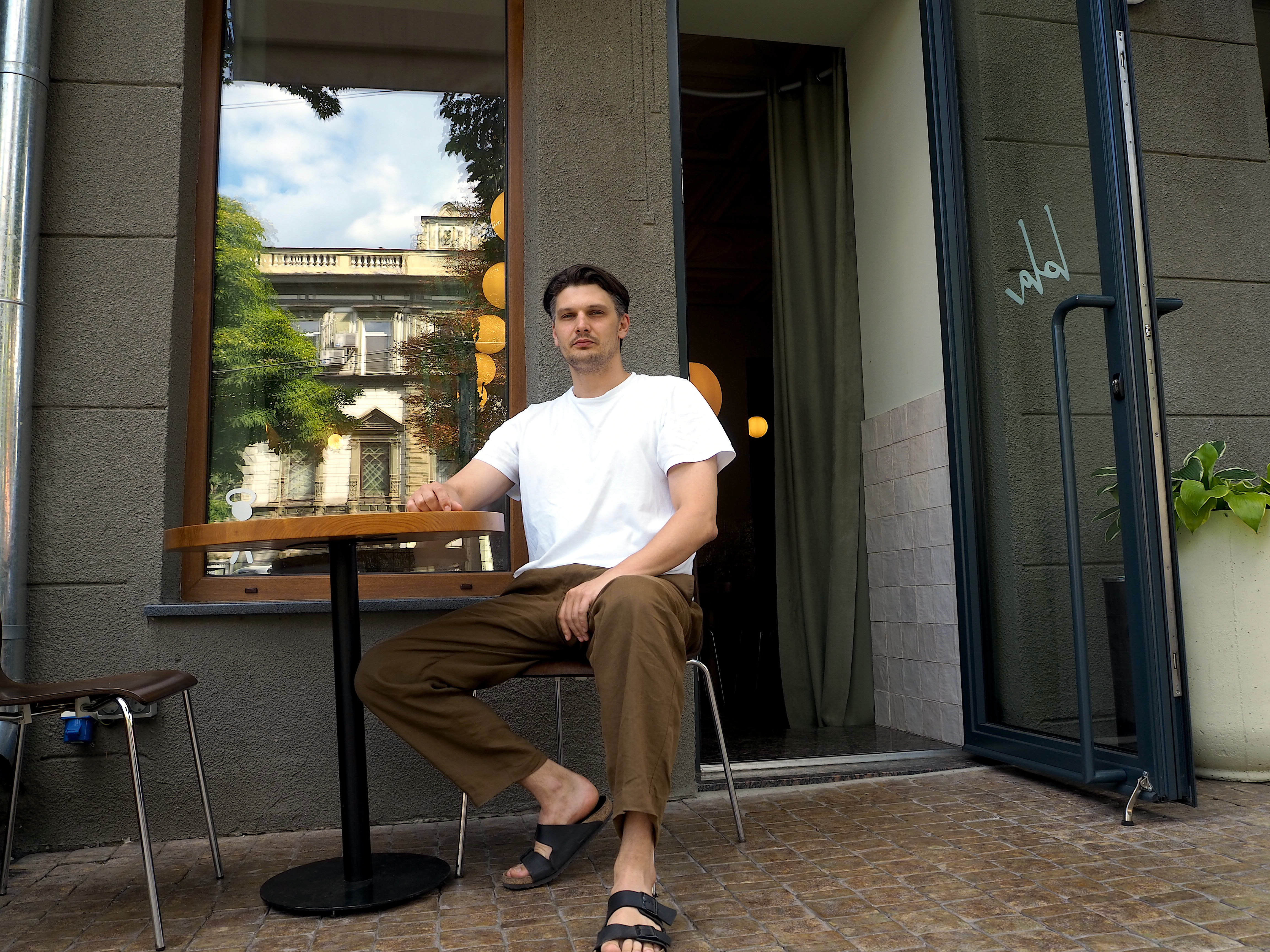 Denys Kalinin, the co-owner of Lola, a French-themed restaurant in the center of Odesa, poses for a photo outside Lola on Aug. 4, 2022. (Alexander Query/The Kyiv Independent)Kalinin said that the drop is mainly due to the lack of tourists in the city.