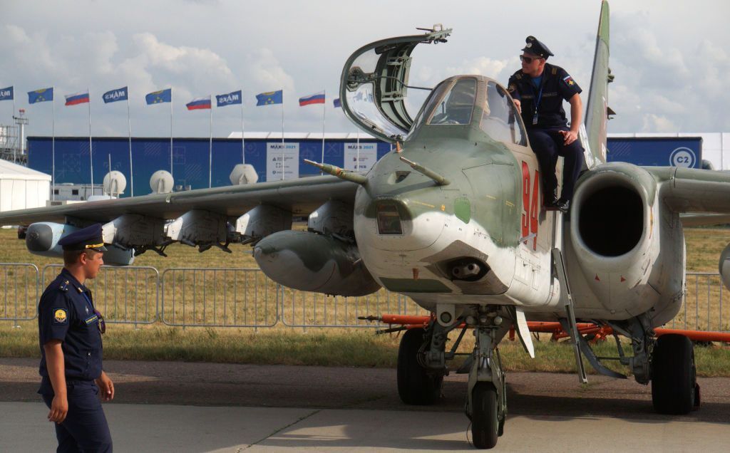 A Russian Air Force officer poses for a photo on a Sukhoi Su-25 jet.