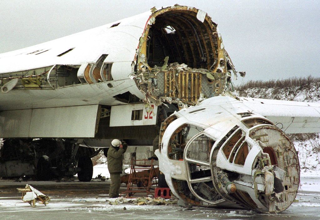 A serviceman works on the destroyed Tupolev Tu-160 strategic bomber at an airbase near Pryluki in central Ukraine Feb. 2, 2001.