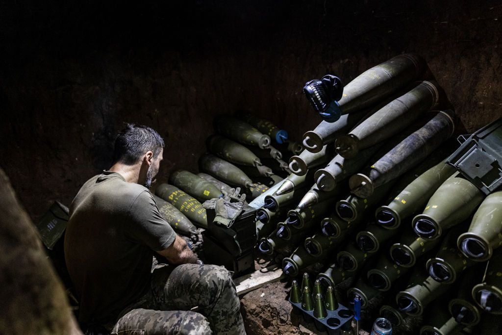 A Ukrainian soldier prepares 155mm artillery shells in his fighting position in Donetsk Oblast.