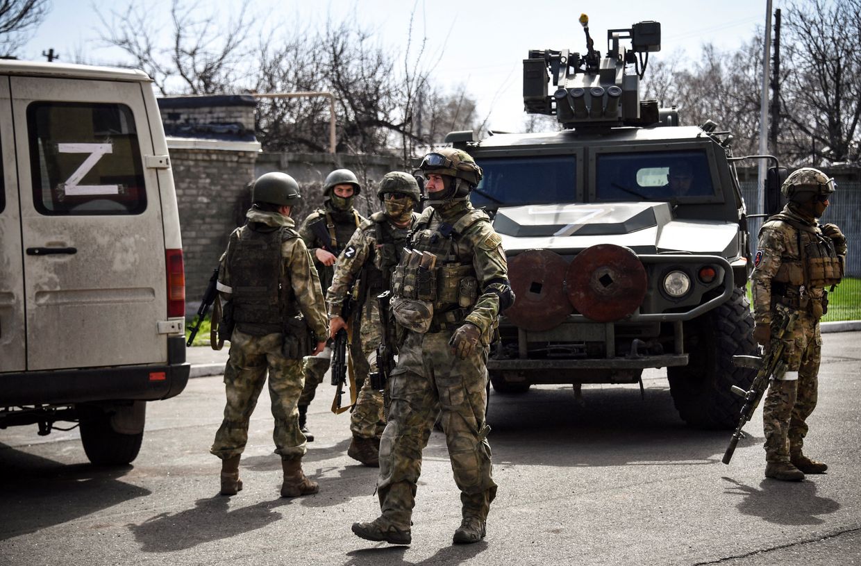 Russian soldiers patrol a street on April 11, 2022, in Volnovakha in the Donetsk region.