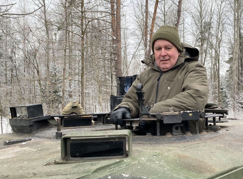 Lithuanian Defense Minister Arvydas Anusauskas rides a Leopard tank at a military training area in Lithuania, Dec. 15, 2023.
