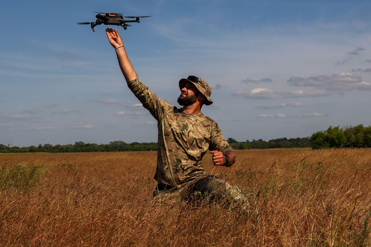 An instructor gives instruction about a DJI drone in Kharkiv, Ukraine, on June 13, 2023