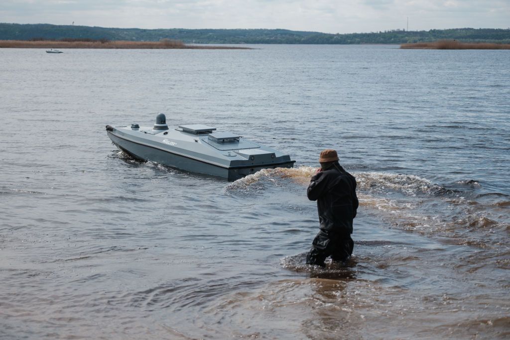 A Ukrainian serviceman of the Main Directorate of Intelligence of the Ministry of Defense of Ukraine launches a naval drone, Magura