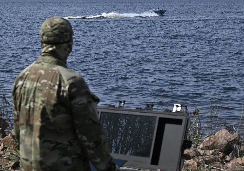 A Ukrainian serviceman controls a naval drone, Magura
