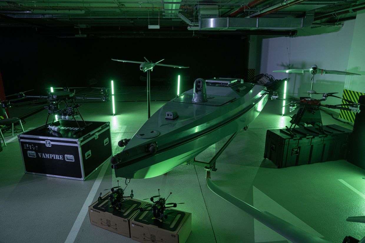 A "Magura"surface combat drone, center, beside aerial drones during a presentation 