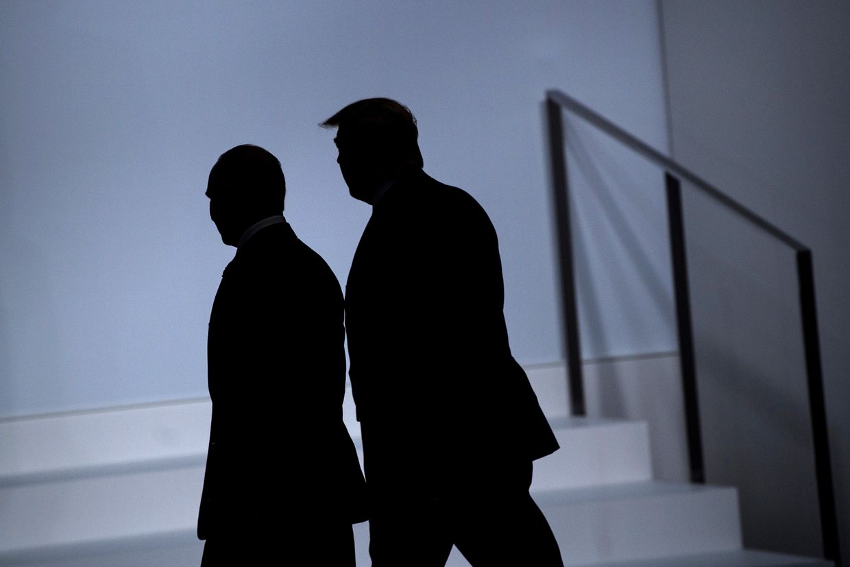 Vladimir Putin (L) and US President Donald Trump arrive for a group photo at the G20 Summit in Osaka, Japan