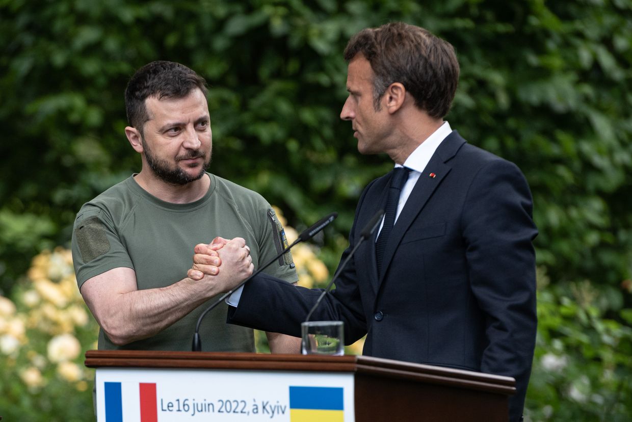 Ukrainian President Volodymyr Zelensky and French President Emmanuel Macron shake hands after a press conference