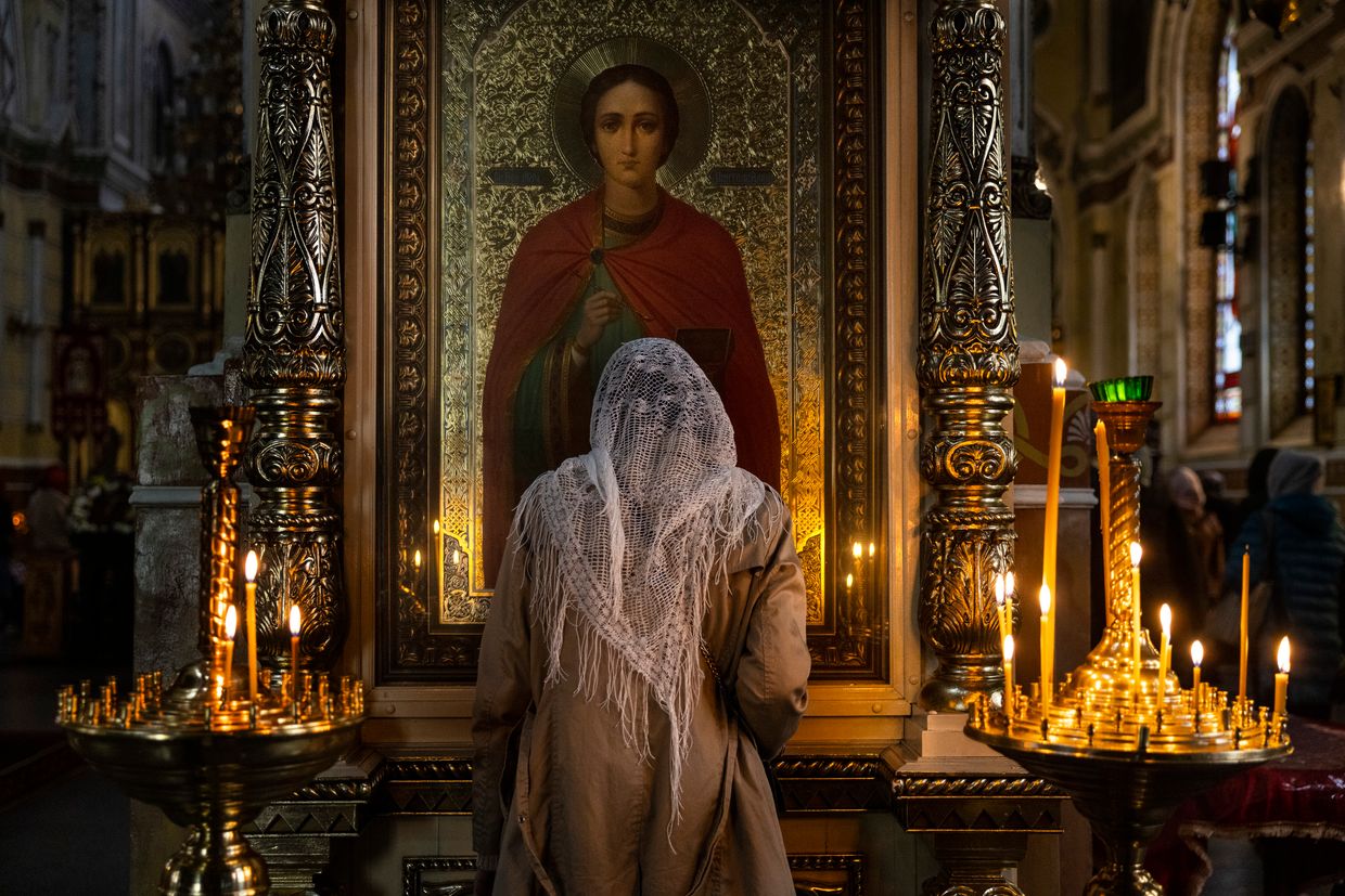 A Ukrainian prays during a Sunday afternoon service at the Pokrovsky Cathedral in Kharkiv, Ukraine, on Oct.2, 2022. 
