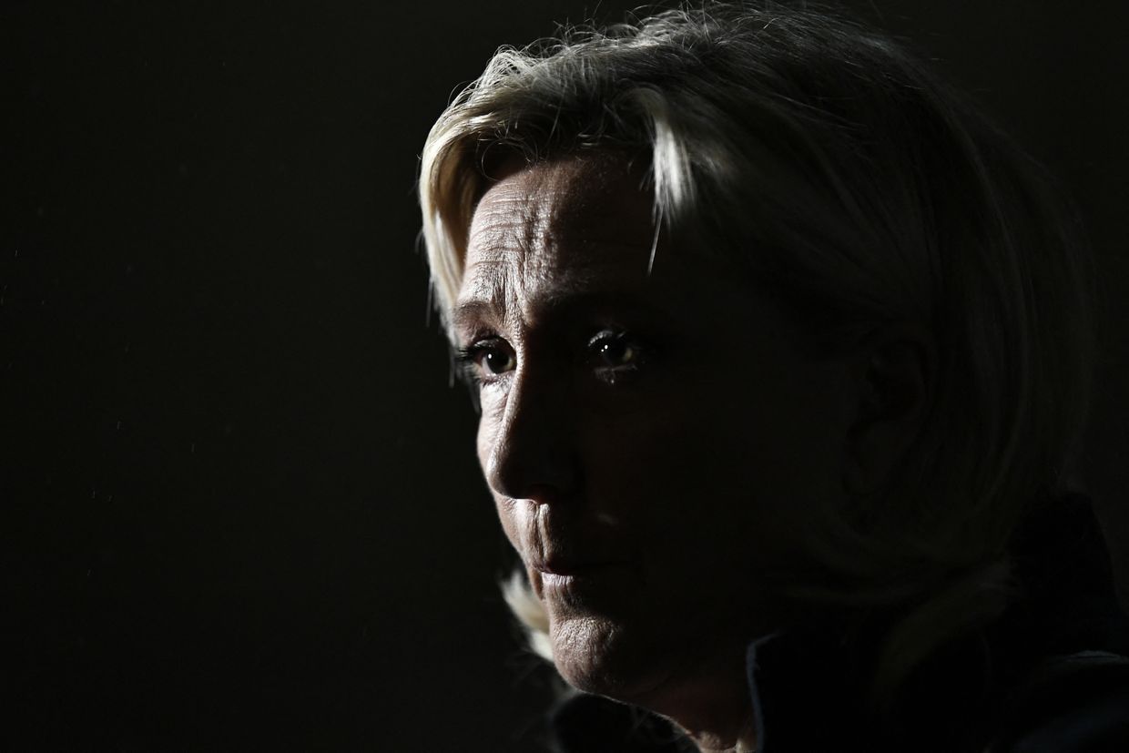 President of the RN parliamentary group Marine Le Pen reacts at the Matignon Hotel