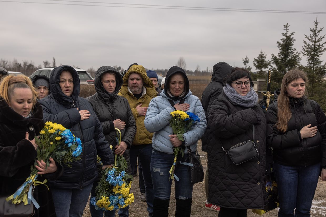 People gather for a memorial service at a cemetery as Ukraine marks the first anniversary of the large-scale Russian invasion of Bukha.