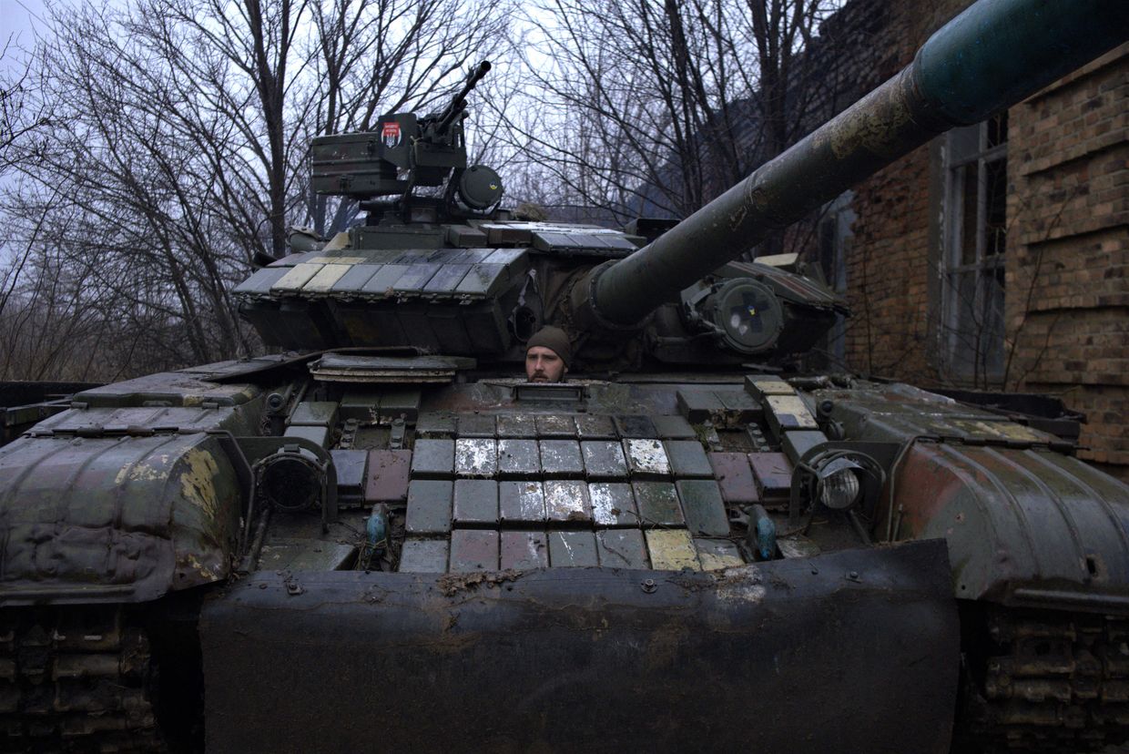 A Ukrainian crewman rides in a T-64 tank, as it makes its way from the town of Chasiv Yar, Donetsk region to Bakhmut