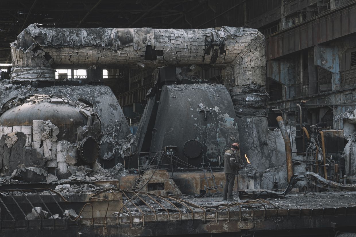 Workers clear the rubble at a thermal power plant, extensively damaged after a Russian missile strike