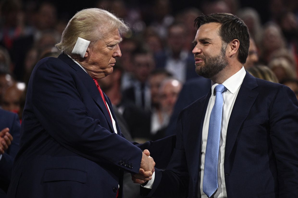 US former President and 2024 Republican presidential candidate Donald Trump (L) shakes hands with US Senator from Ohio and 2024 Republican vice-president candidate J. D. Vance