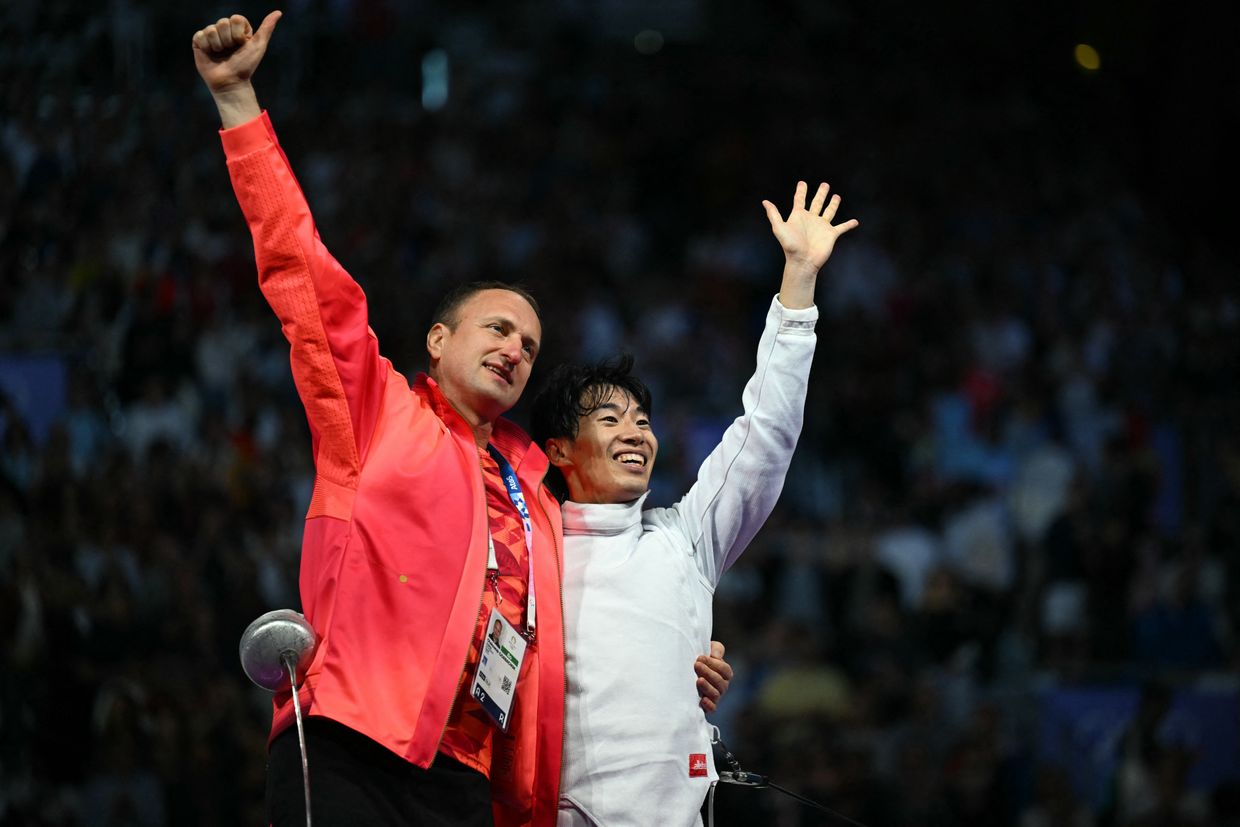 Japanese fencer Koki Kano and his coach Oleksandr Horbachuk celebrate after winning gold at the Paris Olympics.