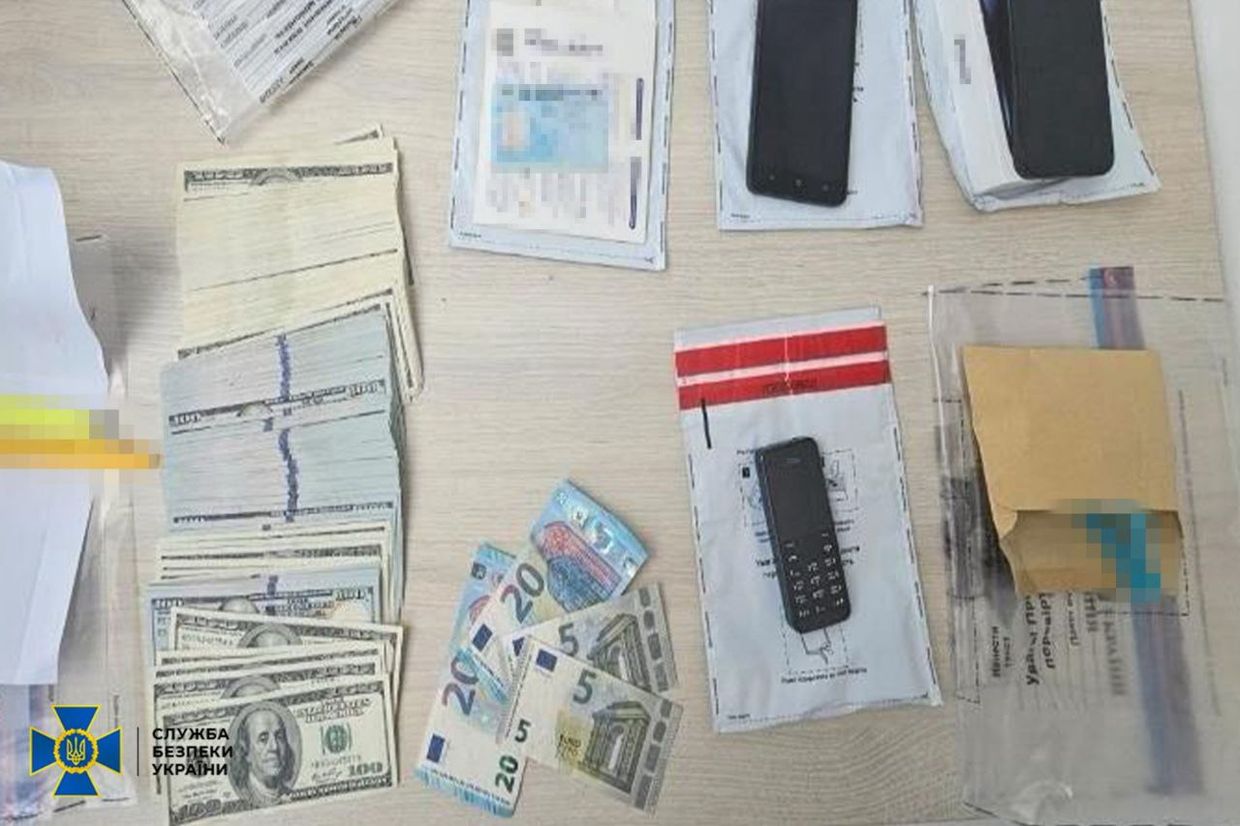 Cash and mobile phones uncovered during searches of suspected Russian agents in Ukraine.