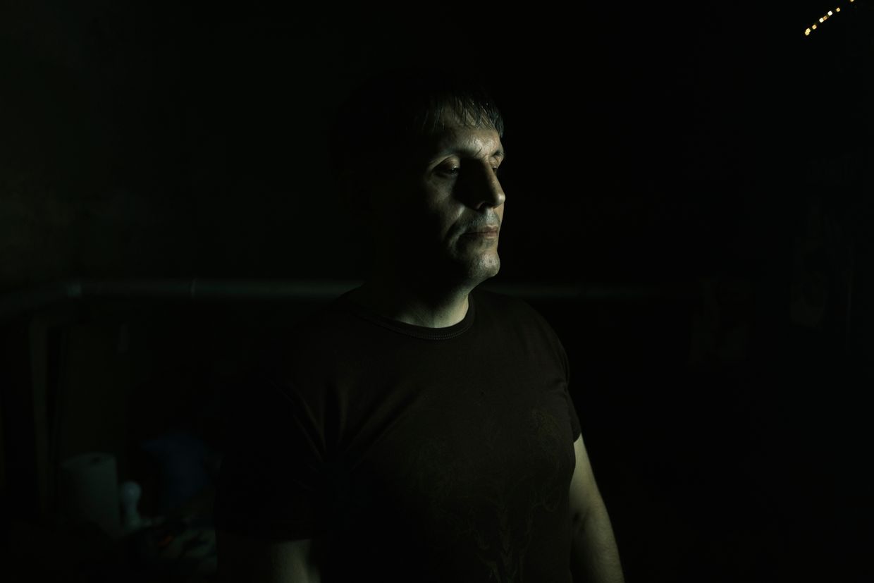 Arthur, 42, a neighbor of Oksana and Tetyana, in his room in the basement in Toretsk, Ukraine, on July 3, 2024