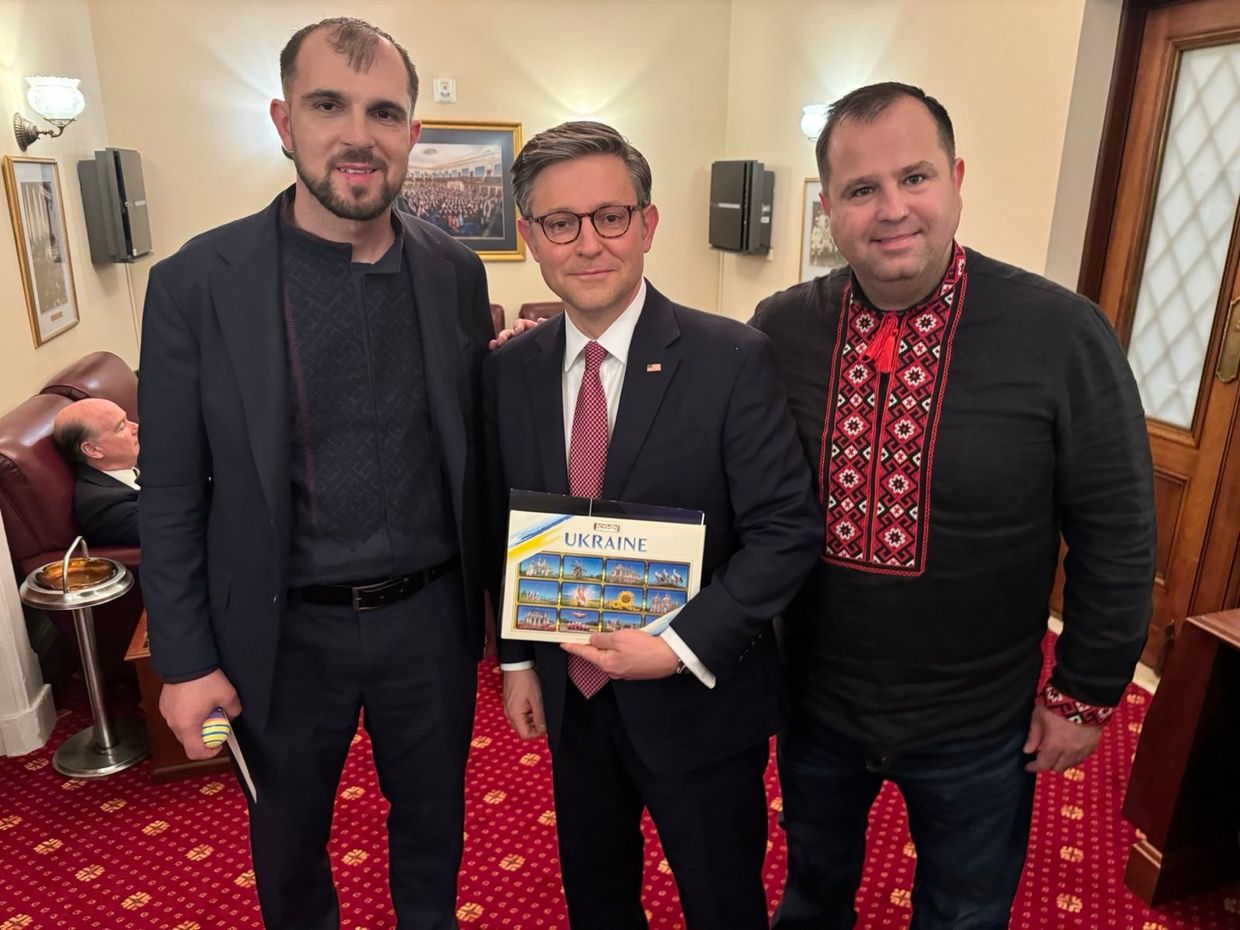 Serhii Gadarzhi (L), who lost his wife and child in a Russian strike on Odesa, Ukraine, with Mike Johnson, U.S. House Speaker (C), and Pavlo Unguryan (R).