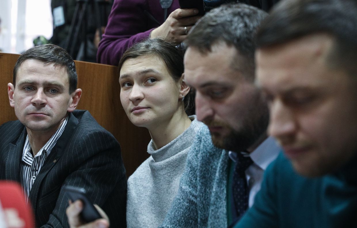 Suspect Yana Duhar sits between her lawyers during a court hearing