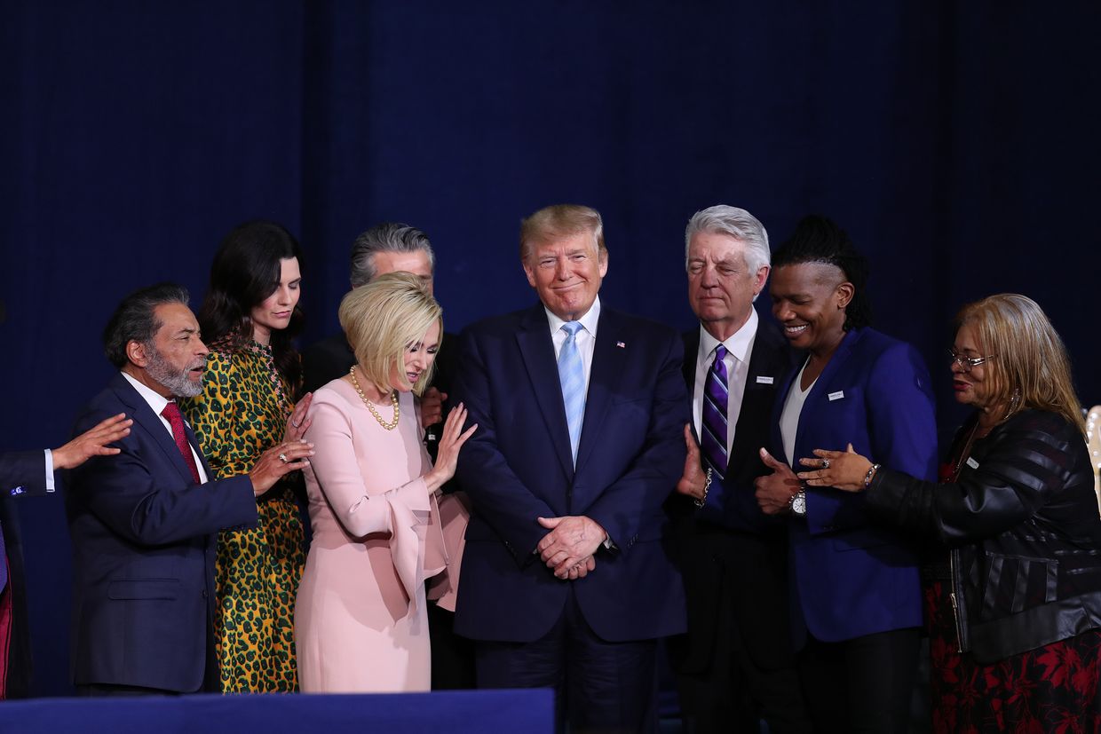 Faith leaders pray over President Donald Trump during a 'Evangelicals for Trump' campaign event held at the King Jesus International Ministry in Miami, Florida, US on Jan. 3, 2020.