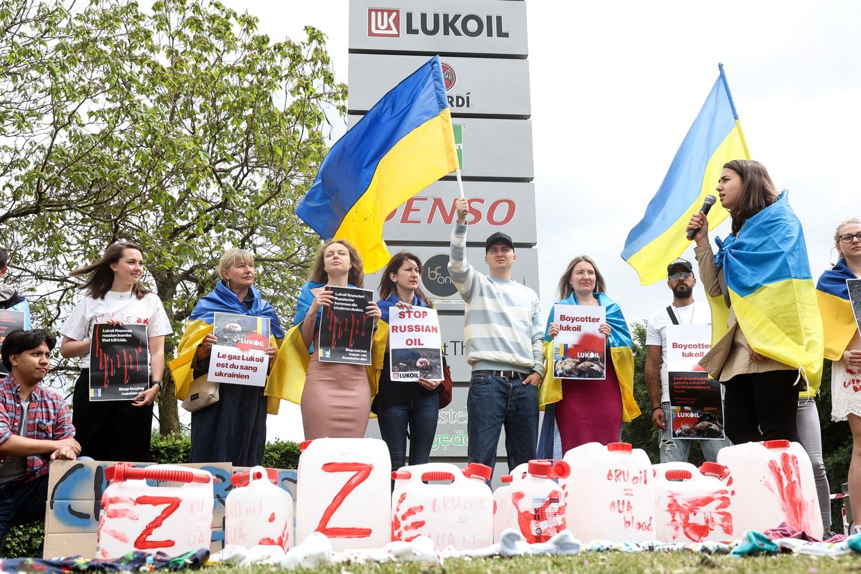 Protestors gather near the Lukoil headquarters to call to boycott the Russian oil company in Brussels, Belgium 