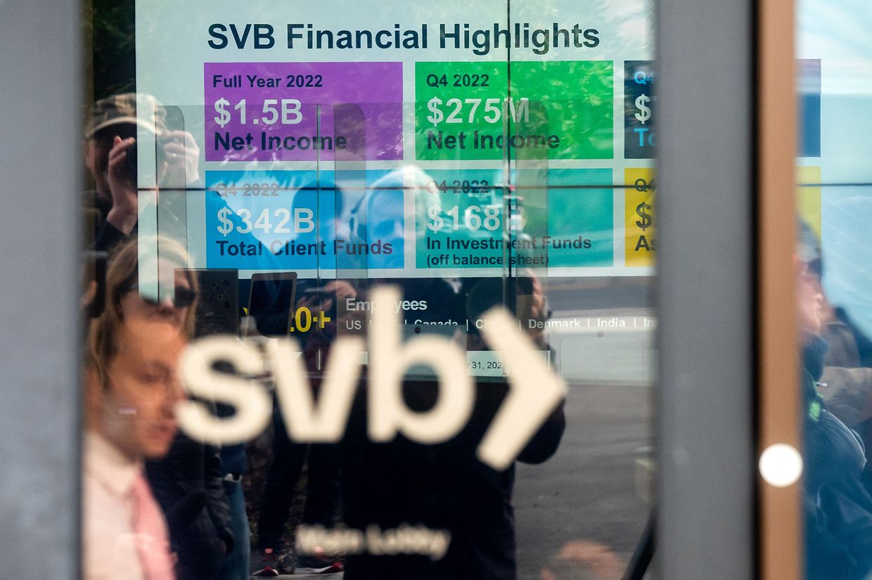 A display lists Silicon Valley Bank (SVB) achievements as customers gather to withdraw money at SVBs headquarters 