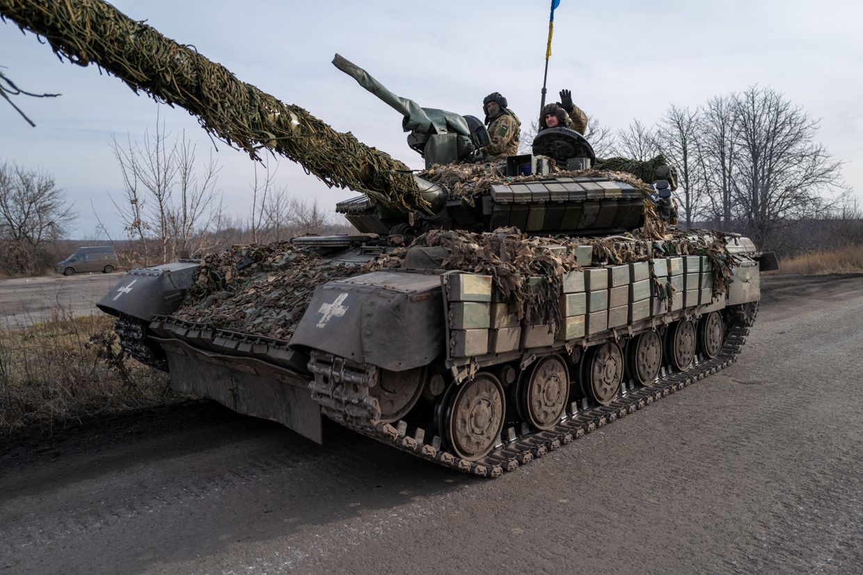 Ukrainian soldiers drive a tank.