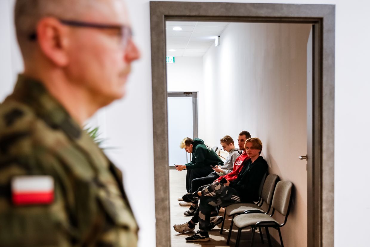  Young men wait in a hall to be seen by a doctor during Myslenice district medical qualification for military service 