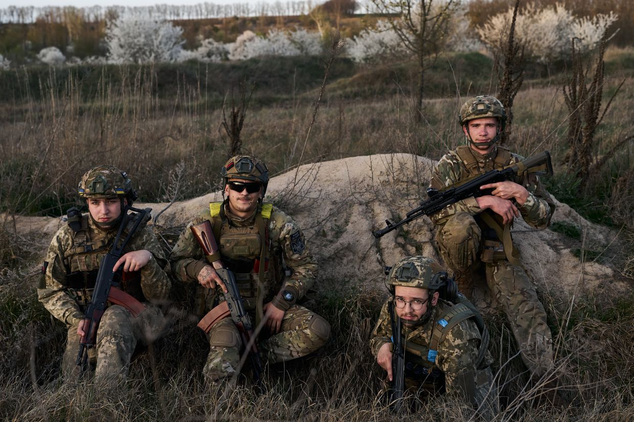 : Young soldiers of the "Da Vinci Wolves" battalion who recently joined the Armed Forces of Ukraine pose in ammunition during orientation training