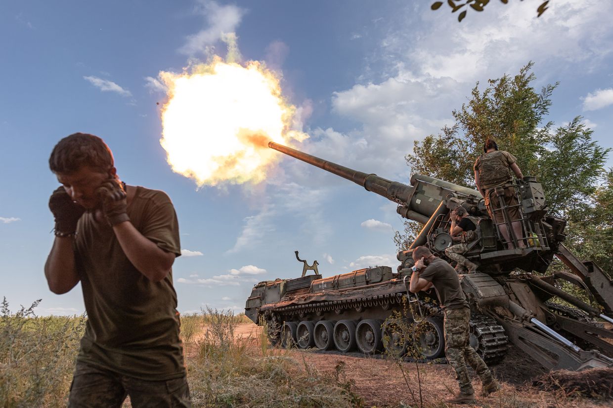 Ukrainian soldiers fire the 'Pion' artillery at their combat position in Donetsk oblast