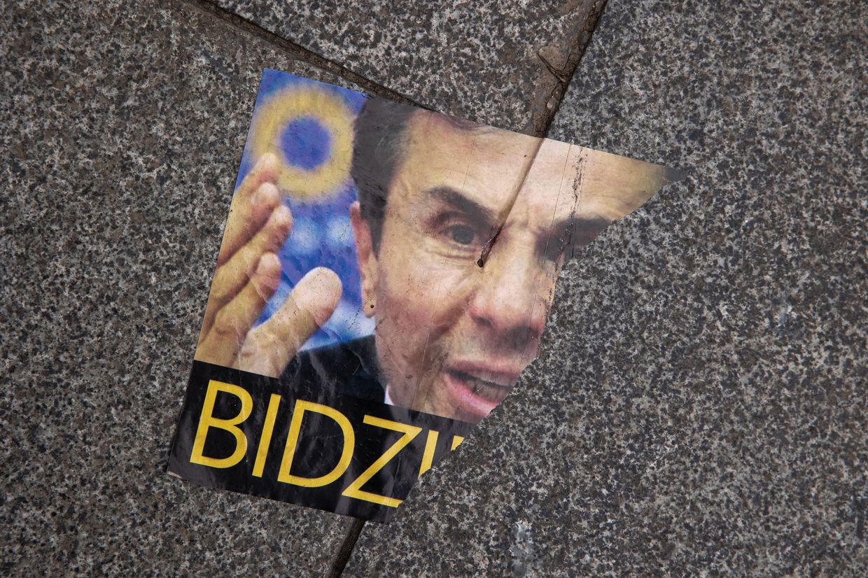 A torn flyer showing Bidzina Ivanishvili