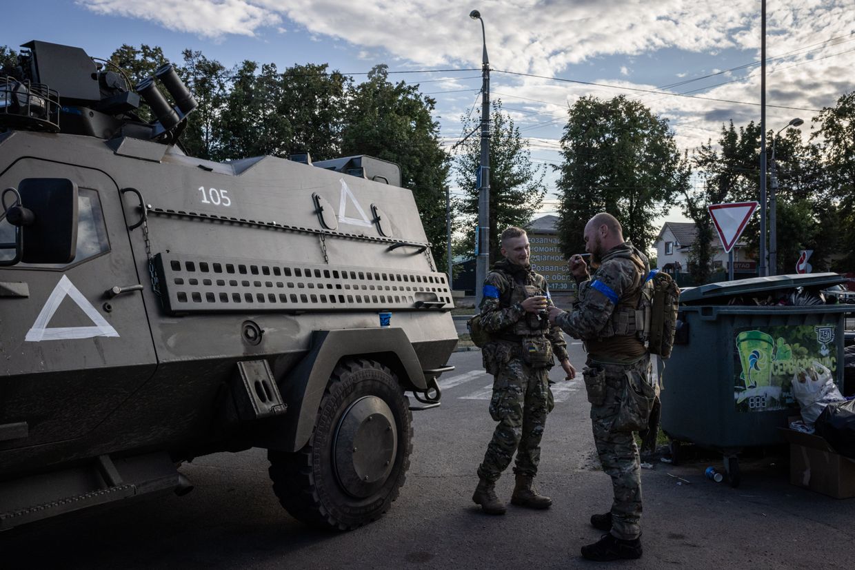 Soldiers drink coffee and east hotdogs between tasks in a petrol station near Sumy on Aug. 15, 2024, in Sumy Region, Ukraine.