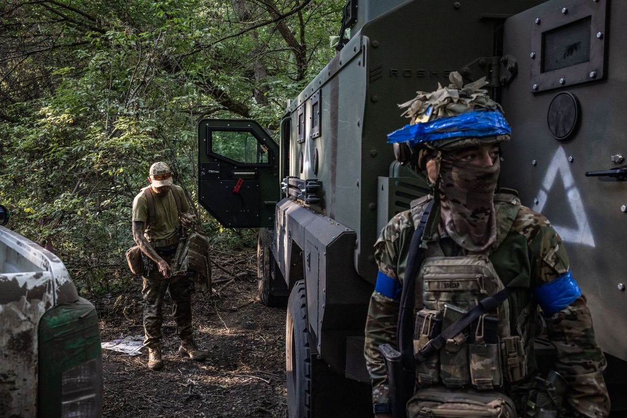 A Ukrainian drone Unit commander with the call sign Boxer (R) stands at a Ukrainian military position in Sudzha