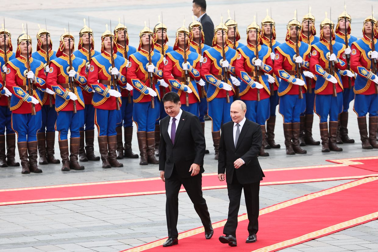 Vladimir Putin and Mongolia's President Ukhnaagiin Khurelsukh walk past honor guards during an official welcoming ceremony in Ulaanbaatar, Mongolia on Sep. 3, 2024