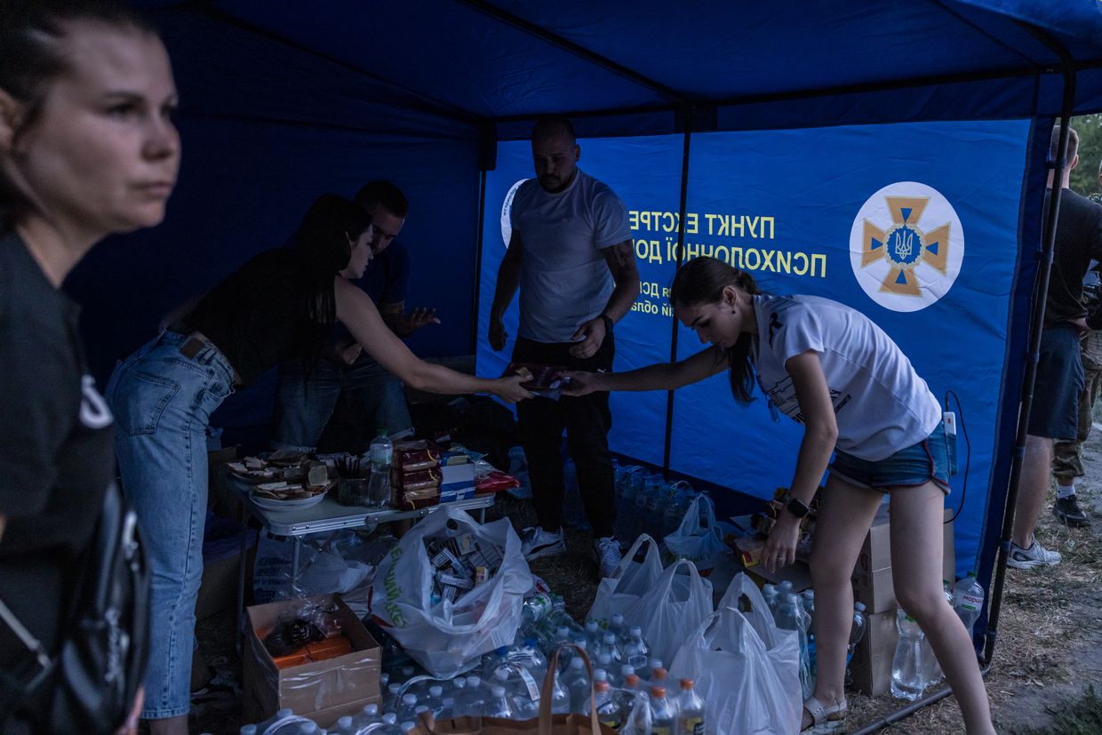 Volunteers organize water and food in the tent near the Military Institute of Telecommunications and Information Technology