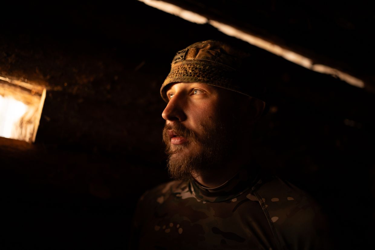 A serviceman of the 78th Air Assault Regiment looks from an observation post in the Chornobyl forest in Chornobyl zone, Kyiv Oblast