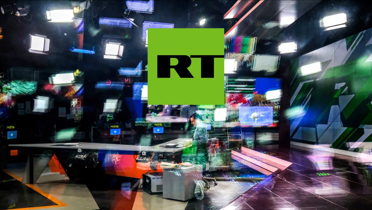 Russia Today's (RT) logo on top of the photo of an unidentified anchor of the Russia Today (RT) TV company 