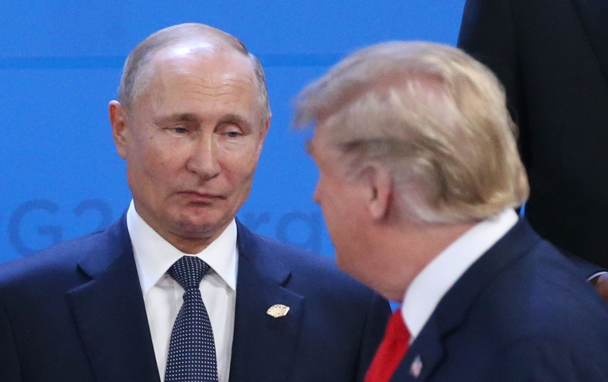 Russian President Vladimir Putin (L) looks at U.S. President Donald Trump during the welcoming ceremony before the G20 Summit in Argentina