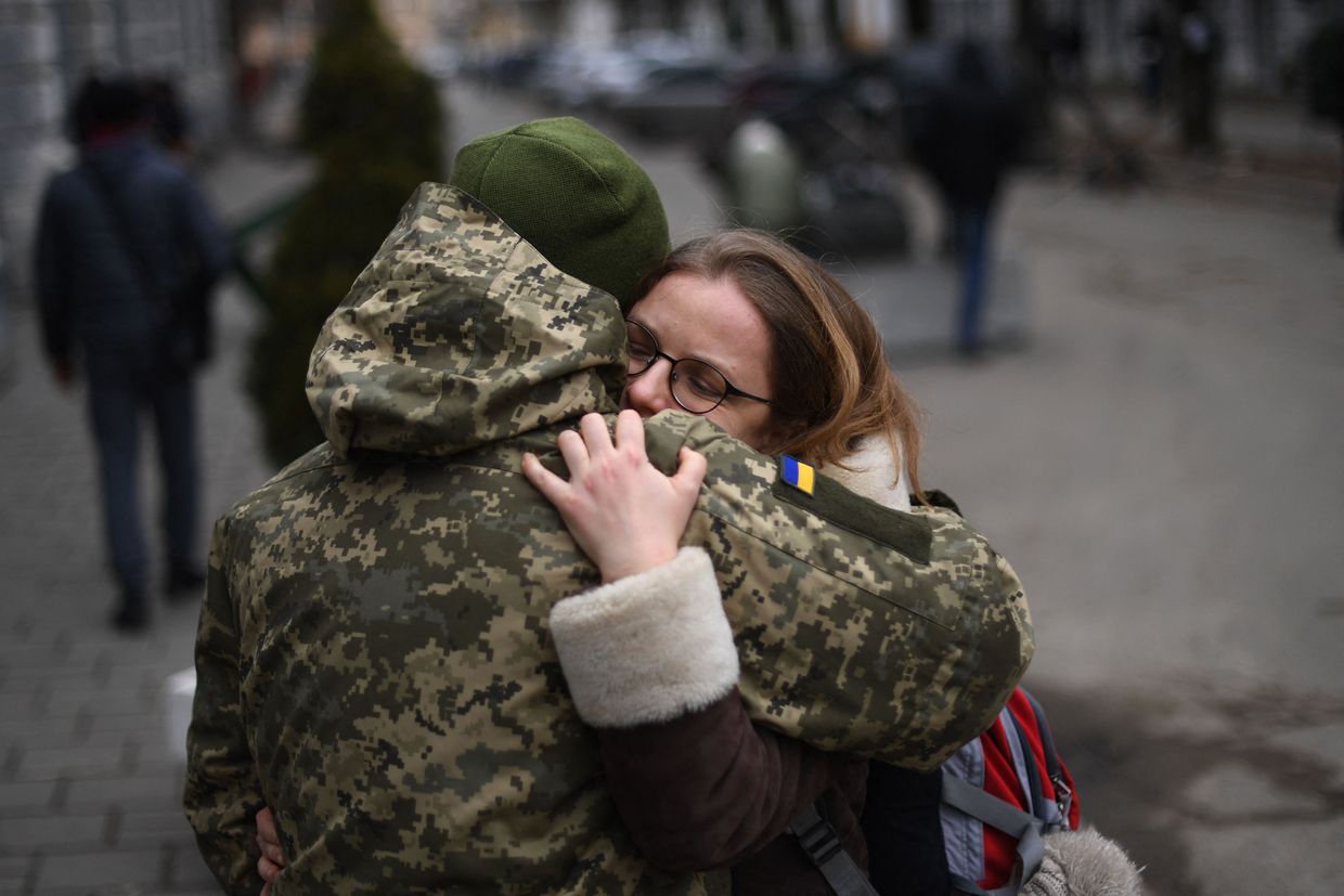 A Ukrainian soldier hugs his partner 