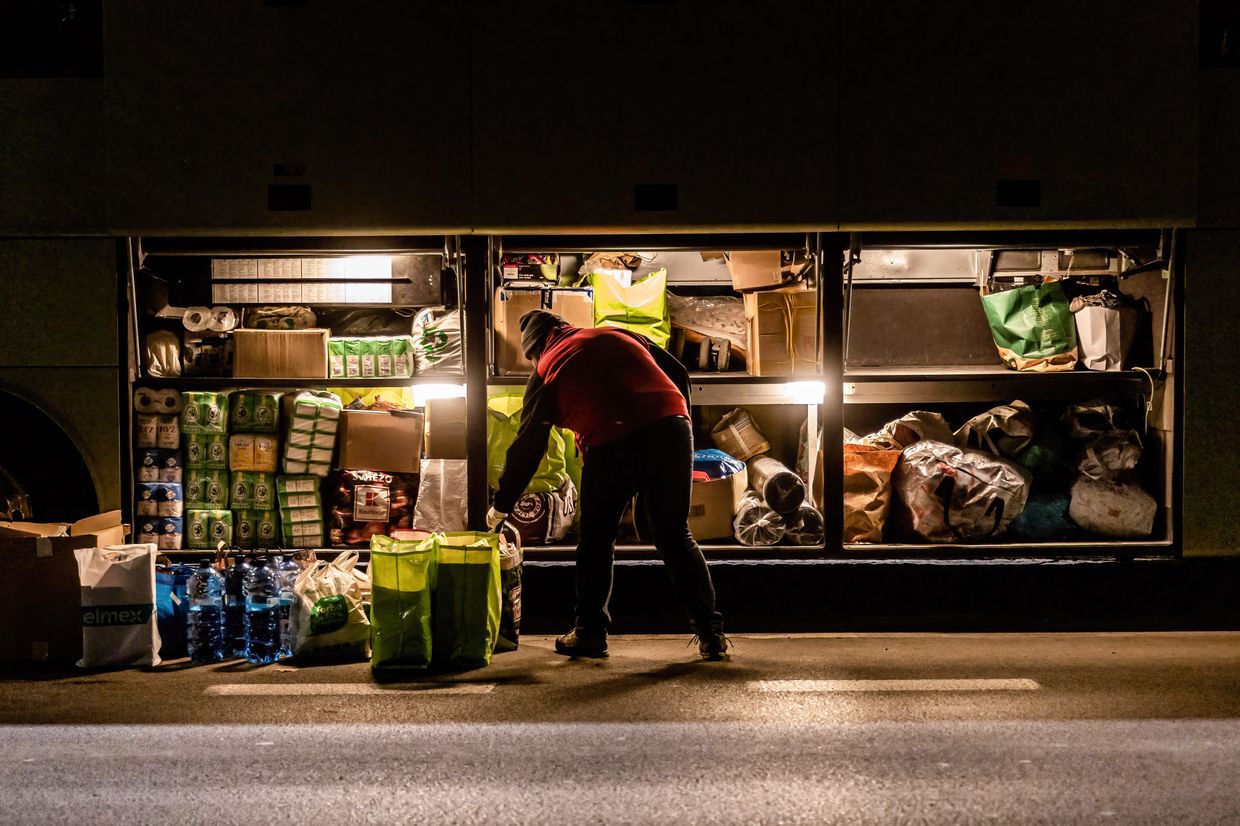 A volunteer loads parcels into a coach to be delivered to Lviv by Abdar Travel Agency in Krakow, Poland, on April 11, 2022. 