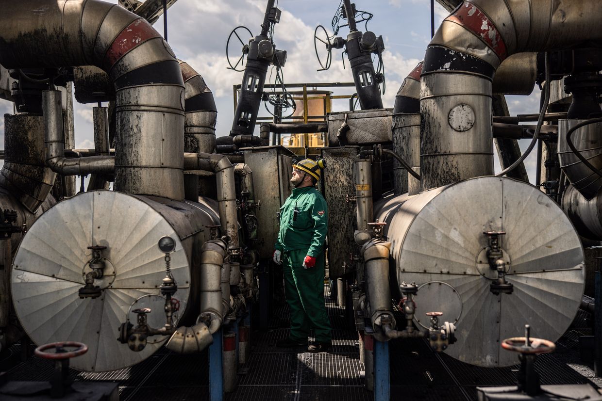 A worker inspects refining structures at the Duna oil refinery, operated by MOL Hungarian Oil & Gas Plc, in Szazhalombatta, Hungary