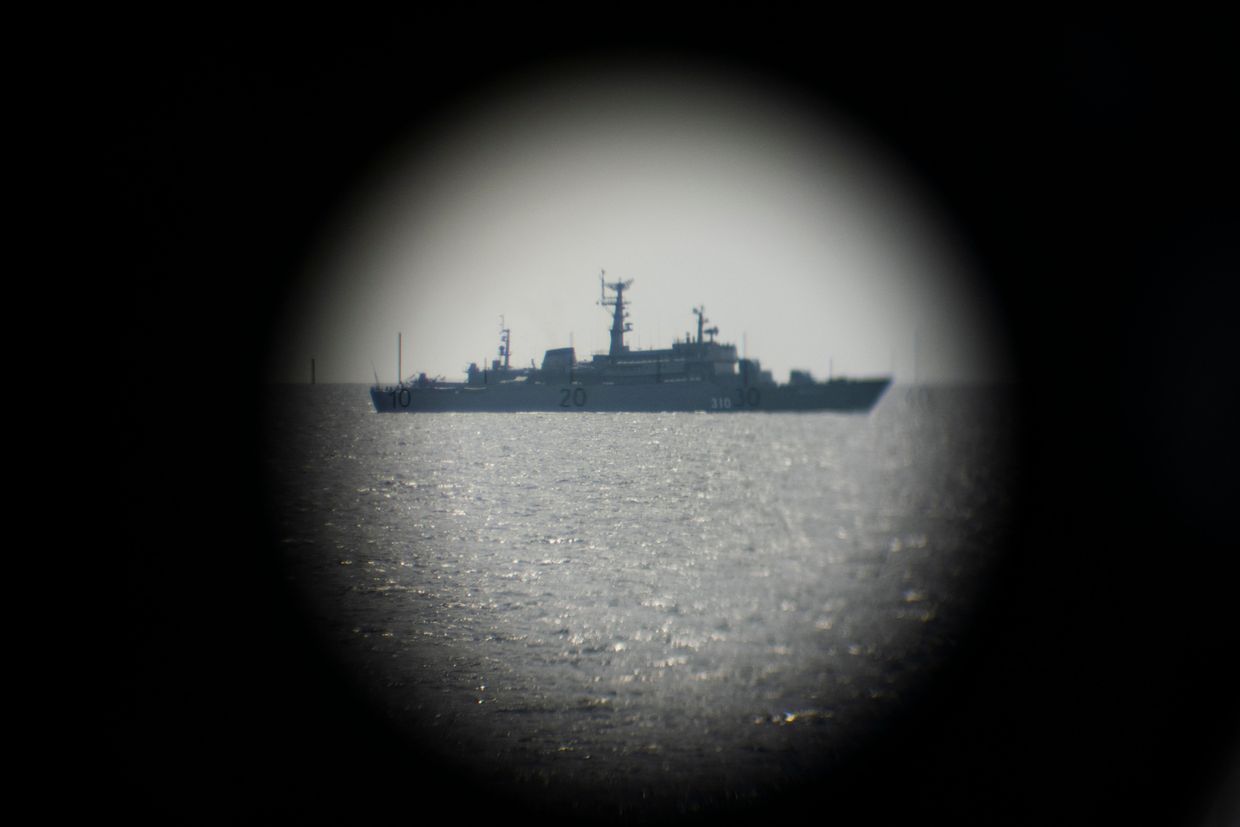  A Russian Navy ship is seen through binoculars as it passes near the German Navy Frigate Sachsen on June 6, 2022, during the BALTOPS 22 Exercise in the Baltic Sea.