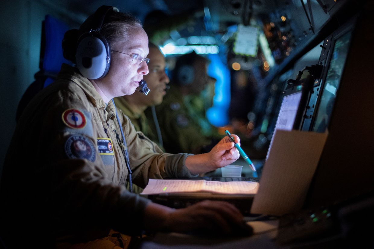  A military operator works aboard the French navy patrol plane Atlantique 2 over the Baltic Sea on June 16, 2022, to locate vessels of Russian interest.