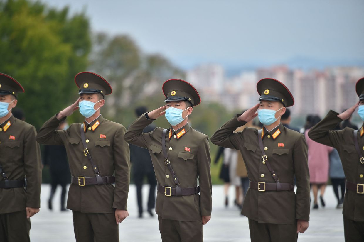 Soldiers salute to pay their respects before the statues of late North Korean leaders Kim Il Sung and Kim Jong Il at Mansu Hill as North Korea marks it 77th anniversary of the founding of the Workers' Party of Korea