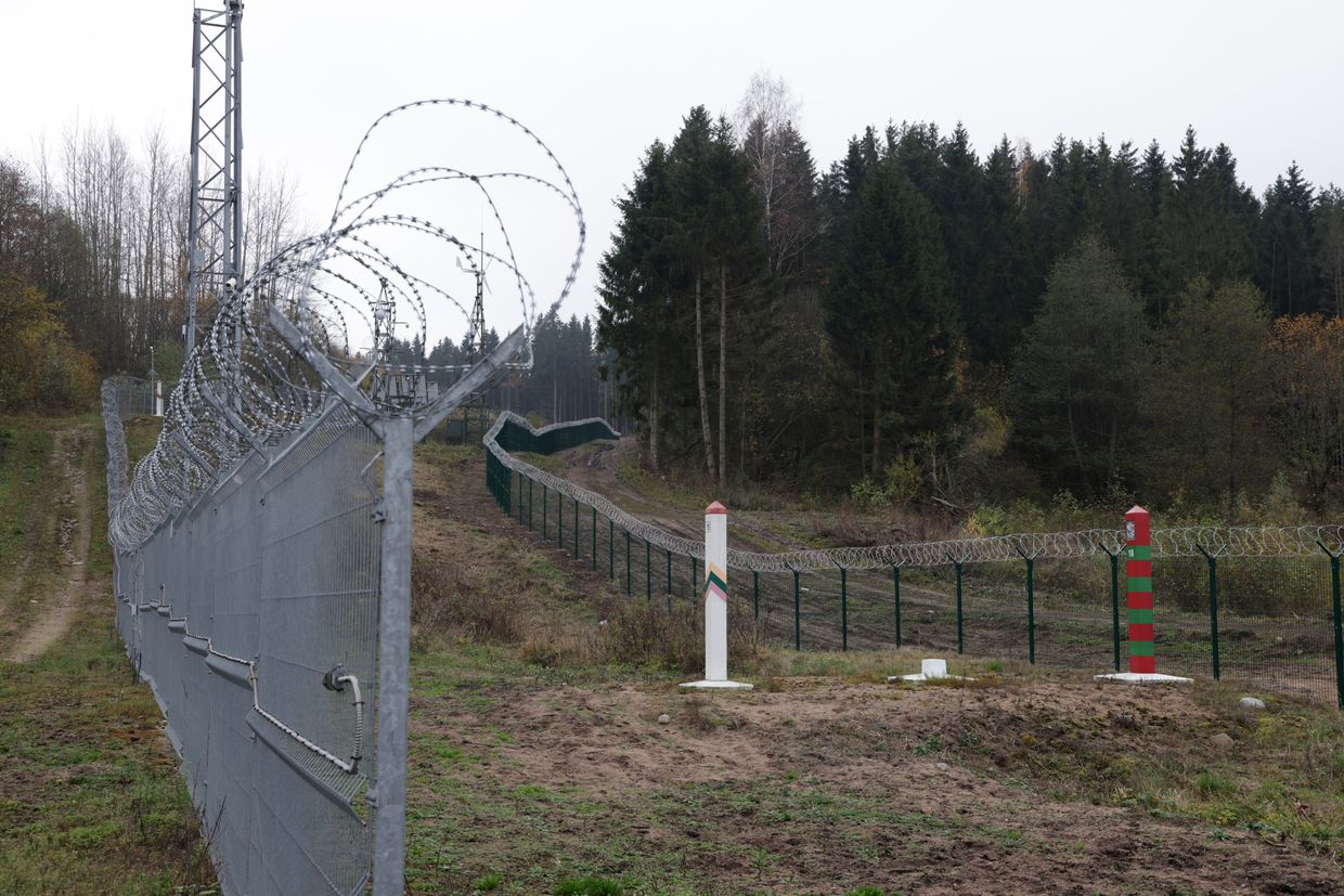 A Lithuanian border fence and marker (L) face a Russian border marker and fence along the border to the Russian semi-exclave of Kaliningrad