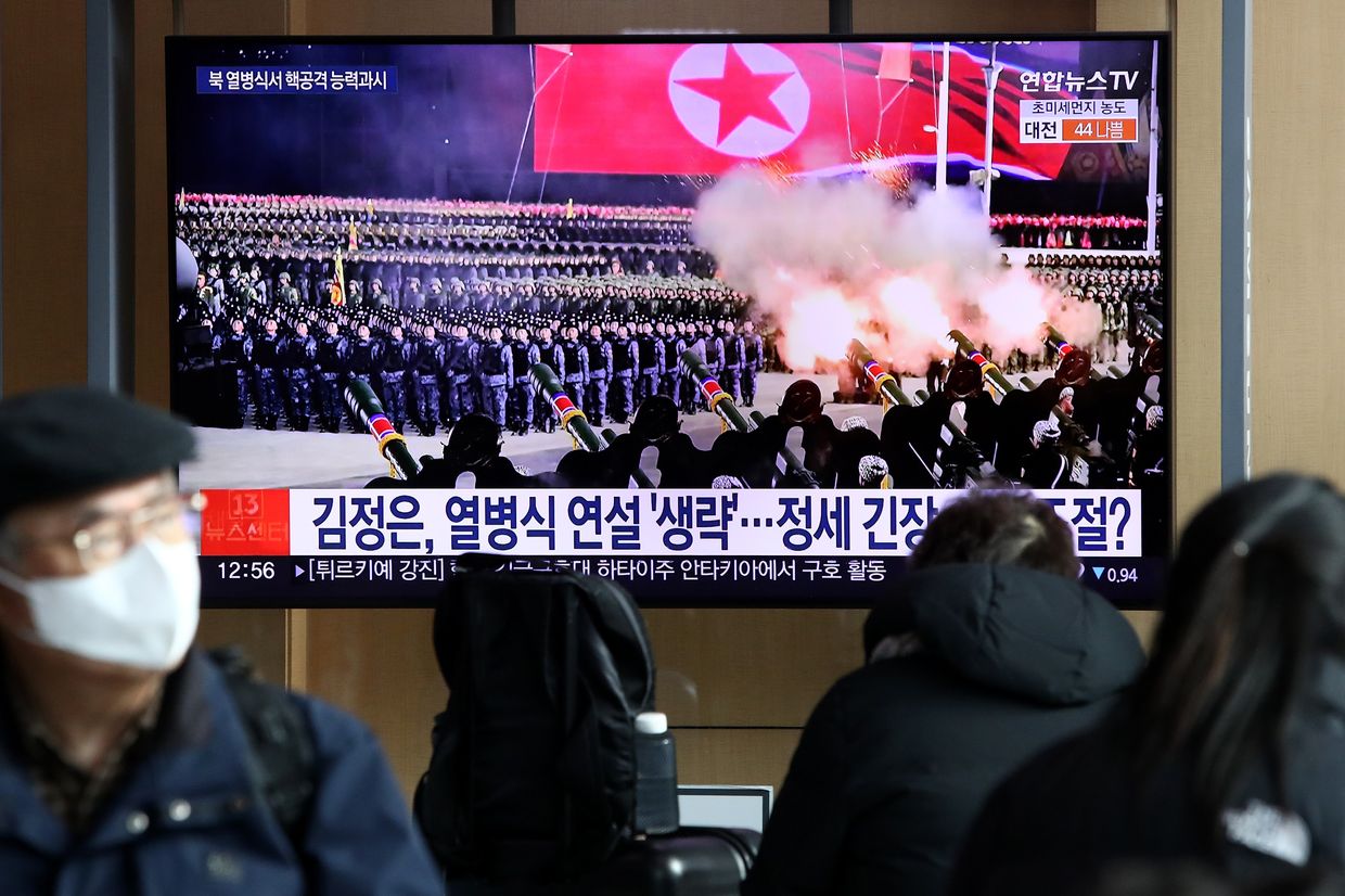 People watch a television show North Korea's 75th anniversary of the founding of the armed forces day military parade released by Korean Central News Agency (KCNA) at the Seoul Railway Station in Seoul, South Korea