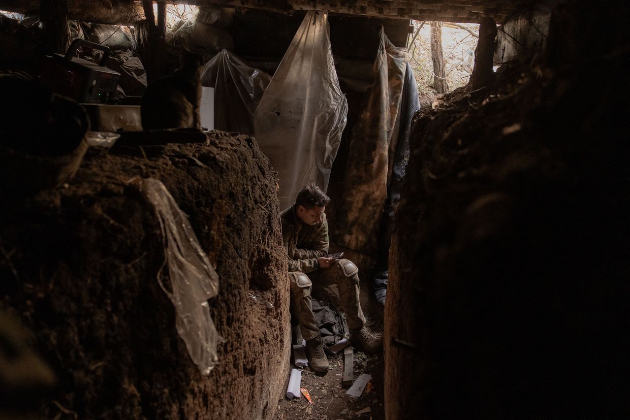 A Ukrainian soldier of the 65th Mechanized Brigade sits on his position in the trench built by Russian forces, and that were captured by the Ukrainian army, near the frontline village of Robotyne, in the Zaporizhzhia Oblast