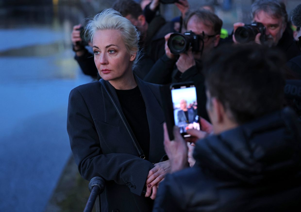 Yulia Navalnaya waits for an Uber, surrounded by media, after voting at the Russian Embassy in Berlin on Mar. 17, 2024.