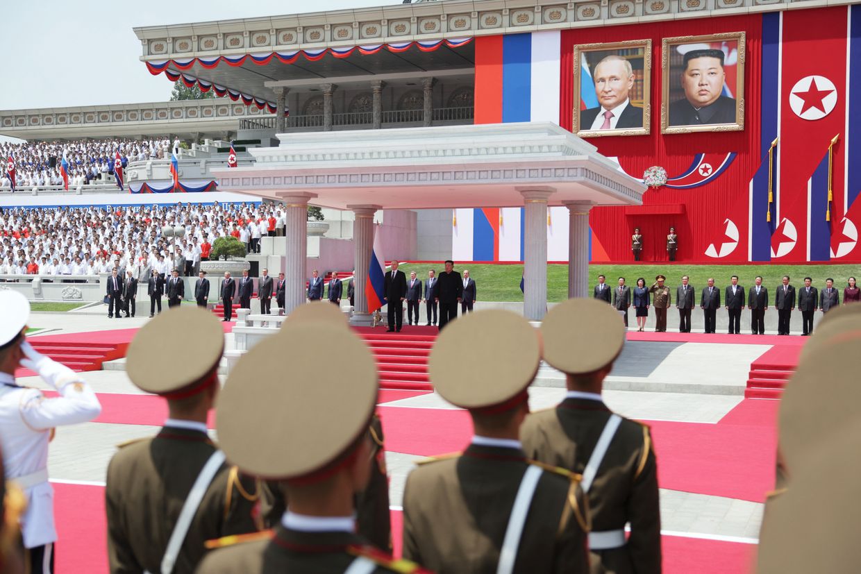             In a pool photo, Putin (left) and Kim Jong Un (right) attend a welcoming ceremony in Pyongyang, North Korea, June 19, 2024.