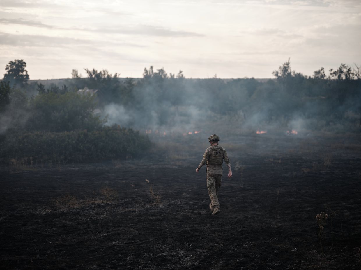  A soldier watches a fire caused by artillery in Donetsk region, Frontline, Ukraine, on Jul. 29, 2024.